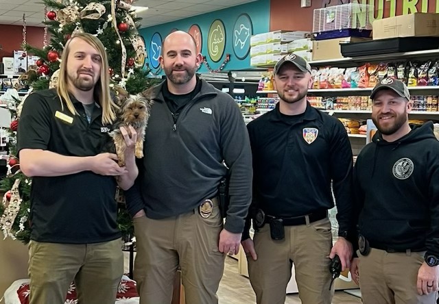 Pet counsellor David Sickman holding Toto, with members of Fairfield Police Department